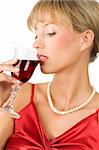 close up of an elegant blond girl with necklace drinking red wine