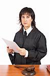 A female judge in a courtroom reading the verdict and striking the gavel. Shallow depth of field