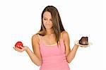 Caucasian woman holding an apple and slice of chocolate cake trying to decide which one to eat