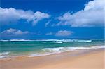 Peaceful beach scene with ocean and blue sky