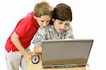 Two adorable brothers using the computer together.  Isolated on white.