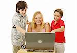A group of kids having fun using a laptop computer.  Isolated on white.