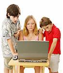 Three children on the computer with serious, confused expressions.  Isolated on white.