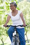 Senior woman on cycle ride in countryside