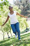 Senior woman exercising in leafy park