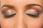 A macro close up of a beautiful woman's make up eye with jewelled false eyelashes
