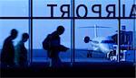 An abstract, motion blur image of people walking down a corridor to board an airplane.