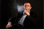 man in suit smoking tobacco-pipe