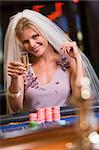 Woman enjoying bridal shower at casino drinking champagne