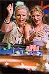 Two women gambling at roulette table in casino