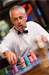 Man placing bet at roulette table in casino