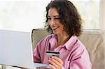 Woman shopping online at home with credit card