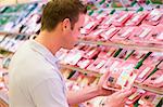 Man buying fresh meat from supermarket