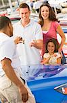 Family collecting new car from dealer