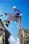 Young man mountain climbing on snowy peak