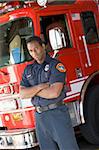 Portrait of a firefighter by a fire engine