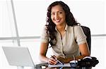 Businesswoman working at desk in office