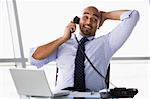Businessman taking call in office
