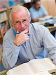 Mature male student studying in library