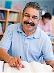 Mature male student studying in library