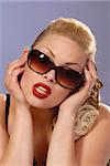 fifties style portrait of beautiful blonde girl in sunglasses