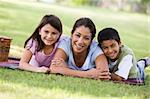 Mother and children having picnic in park