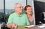 senior couple using an imac computer