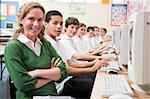 Row of schoolchildren studying in front of a computer