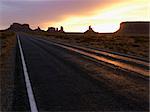 Scenic sunset landscape of highway in Monument Valley on the border of Arizona and Utah, United States.