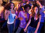 Young men and women dancing in a nightclub