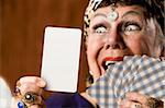Gypsy fortune teller hiolding a blank tarot card