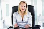 Businesswoman sitting in office with personal organizer