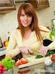 Beautiful woman in kitchen cooking meal