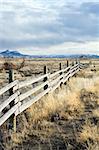 rural fence running through barren Wyoming landscape
