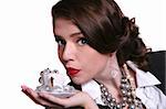 High Fashion Retro Style Woman Holding a Teacup Full of Jewelry