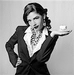 Sexy Woman Dressed in Retro Vintage Style Holding a Teacup in Black and White