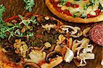 Rustic mushroom and roasted garlic pizza on a vintage oak table