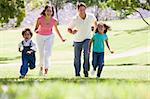 Family running outdoors smiling