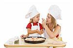 Woman and little girl preparing a pizza - tasting ingredients - isolated