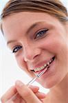 Woman with lipgloss applicator smiling