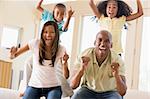Family in living room cheering and smiling