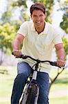 Man outdoors on bike smiling