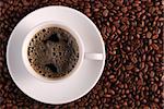 Cup of coffee. A background with coffee grains and a white cup. A photo close up