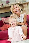 Mother in living room with baby smiling