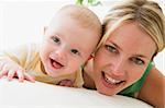 Mother and baby indoors smiling