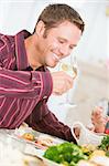 Man Drinking Wine At Christmas Dinner