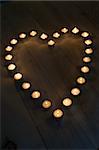 Illuminated Candles Placed In A Heart Shape