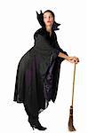 nice witch in black taking pose using a broom as a walking stick