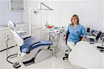 dentist office interior, female doctor sitting at the table