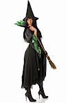 beautiful witch with hat and broom in black and green dress